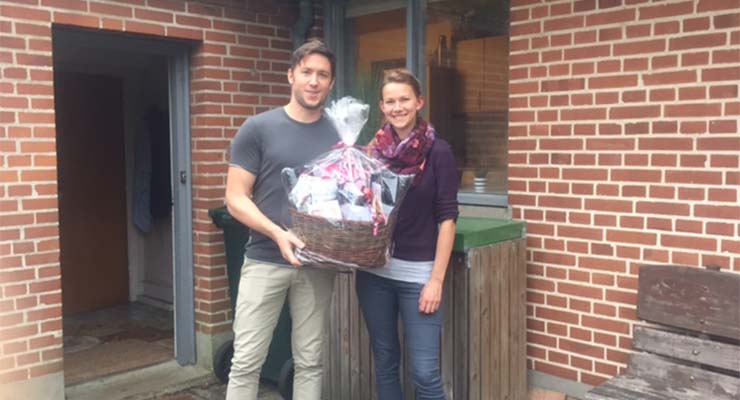 A proud young couple, Kristina and Matt, with a ‘Welcome Basket’ from the Hospitality Minister